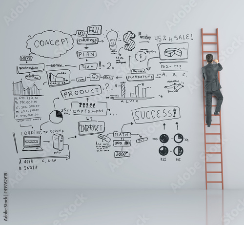 Photo: businessman climbing on ladder businessman climbing on ladder