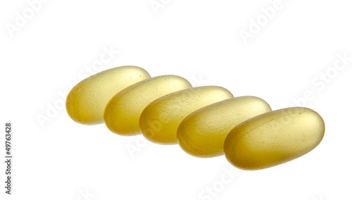 Photo: Yellow semi-transparent pills isolated on white background Yellow semi-transparent pills isolated on white background