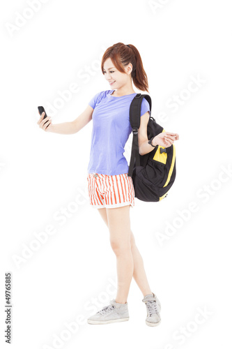 Photo: happy asian girl looking the smart phone in the hand happy asian girl looking the smart phone in the hand