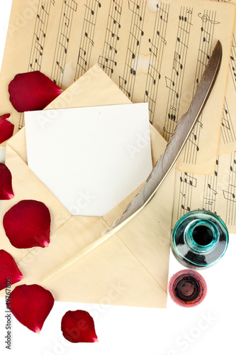 Photo: Old envelope with blank paper and dried rose petals Old envelope with blank paper and dried rose petals