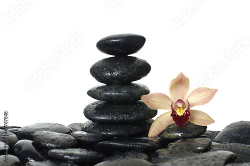 Photo: stones stack in balance with orchid flower stones stack in balance with orchid flower