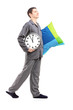 Full length portrait of a young man with pillow and clock sleepw