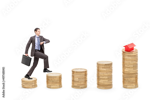 Photo: Full length portrait of a businessman with a briefcase walking o Full length portrait of a businessman with a briefcase walking o