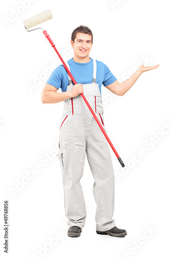 Photo: Full length portrait of a painter in a uniform with a brush poin Full length portrait of a painter in a uniform with a brush poin