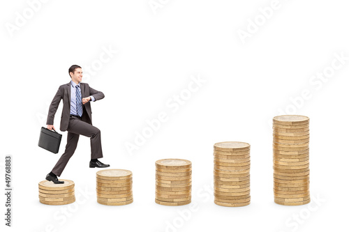 Photo: Full length portrait of an ambitious businessman with a briefcas Full length portrait of an ambitious businessman with a briefcas