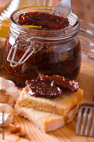 Photo: Sliced bread with dried tomato under oil. Sliced bread with dried tomato under oil.
