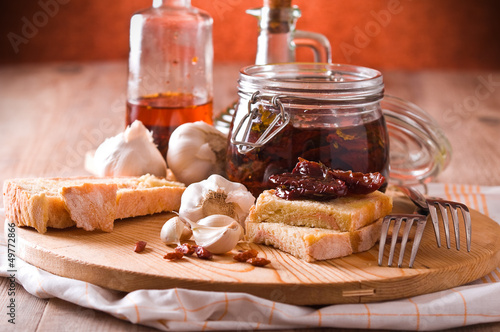 Photo: Sliced bread with dried tomato under oil. Sliced bread with dried tomato under oil.