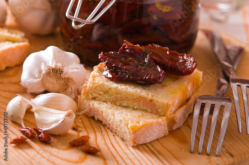 Photo: Sliced bread with dried tomato under oil. Sliced bread with dried tomato under oil.