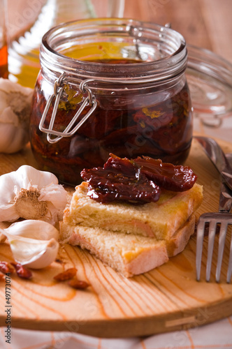 Photo: Sliced bread with dried tomato under oil. Sliced bread with dried tomato under oil.