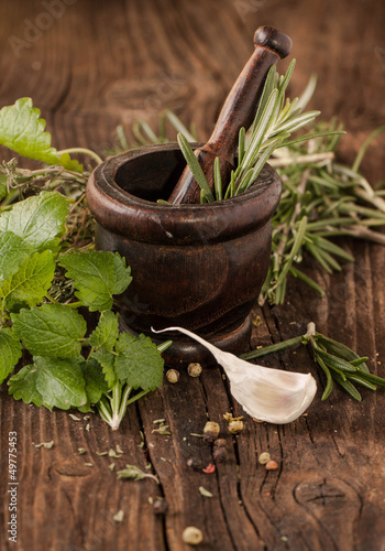Photo: garlic and herbs in mortar garlic and herbs in mortar