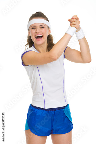 Photo: Happy female tennis player rejoicing success Happy female tennis player rejoicing success