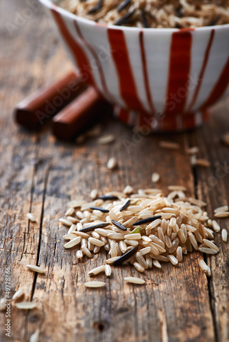 Photo: Brown and wild rice on wooden background Brown and wild rice on wooden background