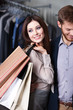 Foto: Glad beautiful woman is in the shop with her boyfriend Glad beautiful woman is in the shop with her boyfriend