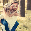 a young couple in love having fun in the spring forest a young couple in love having fun in the spring forest