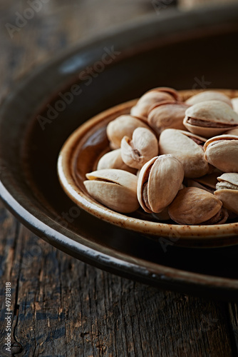 Photo: Pistachios on a dark ceramic plate Pistachios on a dark ceramic plate