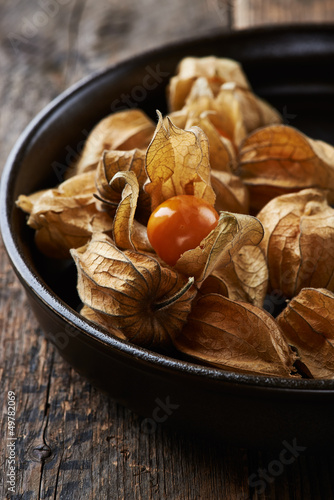 Photo: Ripe physalis in a dark ceramic dish Ripe physalis in a dark ceramic dish