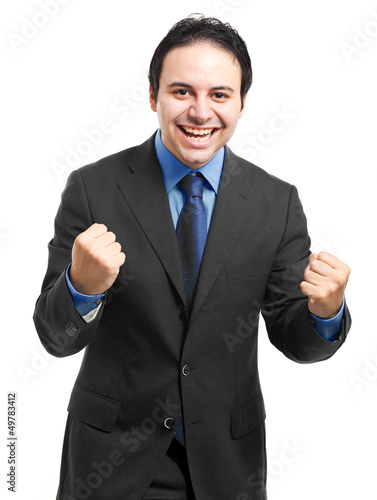 Photo: Business man throwing fists in air and smiling Business man throwing fists in air and smiling
