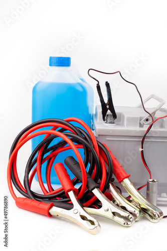 Photo: Car battery and jumper cables isolated on white Car battery and jumper cables isolated on white