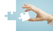 hand puts puzzle