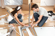 Couple moving in together assembling furniture table