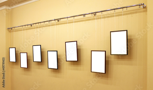 Photo: Seven frames with isolated canvas on the exhibition ledge Seven frames with isolated canvas on the exhibition ledge