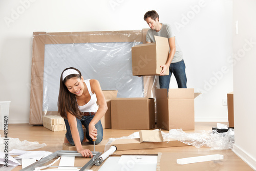 Photo: Couple moving in new home house Couple moving in new home house