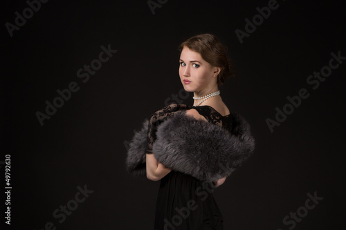 Photo: The girl in the retro image of a black background The girl in the retro image of a black background