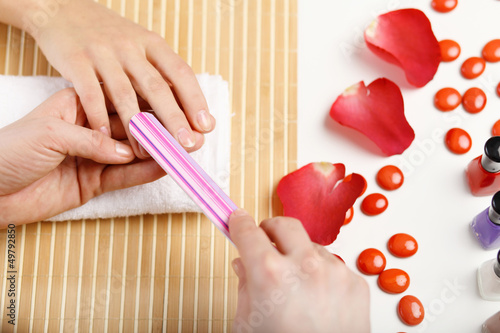 Photo: Woman is getting manicure Woman is getting manicure