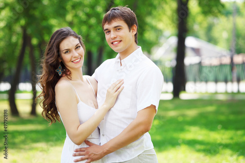 Photo: Young love Couple smiling under blue sky Young love Couple smiling under blue sky