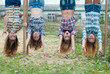 Photo: Four young girls hanging upside down in park Four young girls hanging upside down in park