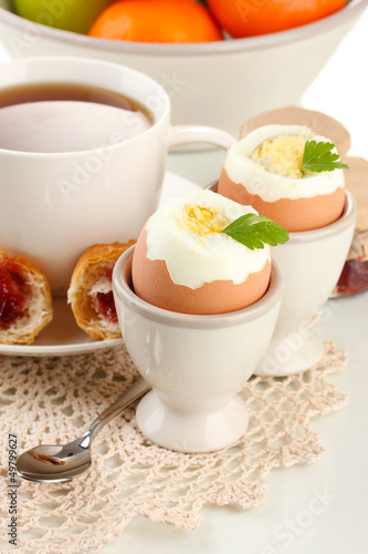Photo: Light breakfast with boiled eggs and coffee, close up Light breakfast with boiled eggs and coffee, close up