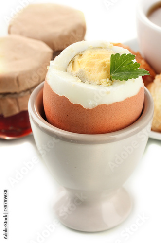 Photo: Light breakfast with boiled egg and coffee, isolated on white Light breakfast with boiled egg and coffee, isolated on white