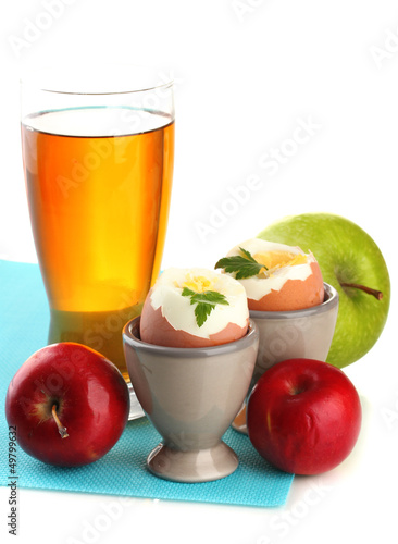 Photo: Light breakfast with boiled eggs and glass of juice, isolated Light breakfast with boiled eggs and glass of juice, isolated