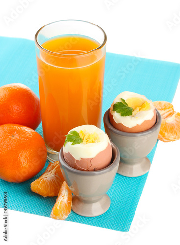Photo: Light breakfast with boiled eggs and glass of juice, isolated Light breakfast with boiled eggs and glass of juice, isolated