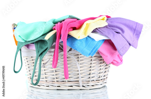 Photo: Clothes in wooden basket isolated on white Clothes in wooden basket isolated on white