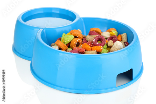 Photo: Dry dog treats in bowl isolated on white Dry dog treats in bowl isolated on white