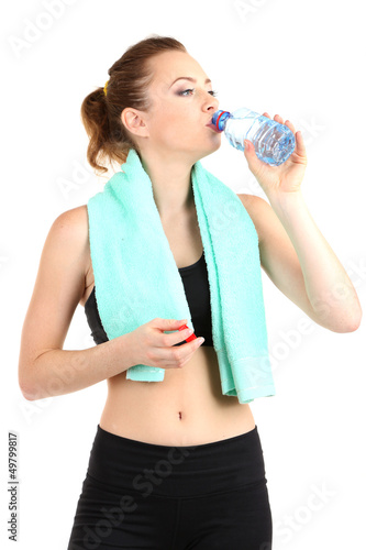 Photo: Young woman with water after workout isolated on white Young woman with water after workout isolated on white