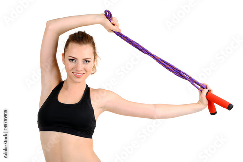 Photo: Young woman with skipping rope isolated on white Young woman with skipping rope isolated on white