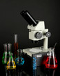 Test tubes with colorful liquids and microscope