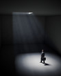 Illustration: A lonely man standing in a spot of light A lonely man standing in a spot of light