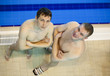 Two swimmers are on the edge of the pool. top view