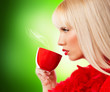Beautiful blonde young woman with coffee or tea
