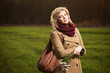 Young woman with a flowers in autumn field