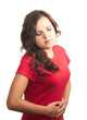Attractive girl in red shirt is suffering from abdominal pain.