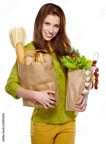 Photo: beautiful young woman with vegetables and fruits in shopping bag beautiful young woman with vegetables and fruits in shopping bag