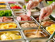 Tray with  food  on showcase at cafeteria