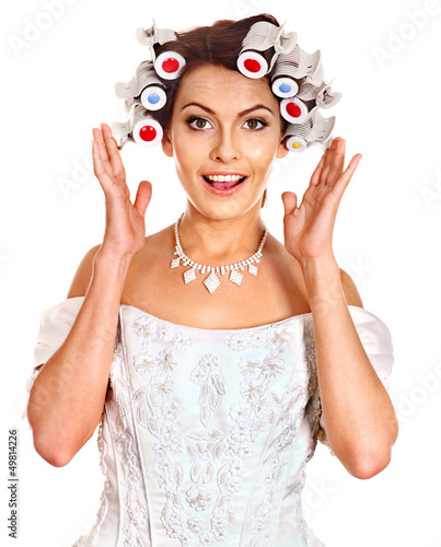 Photo: Woman wear hair curlers on head. Woman wear hair curlers on head.