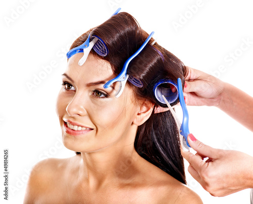 Photo: Woman wear hair curlers on head. Woman wear hair curlers on head.