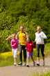 Family running in the meadow for sport