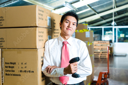 Photo: Young Man in a warehouse with Scanner Young Man in a warehouse with Scanner